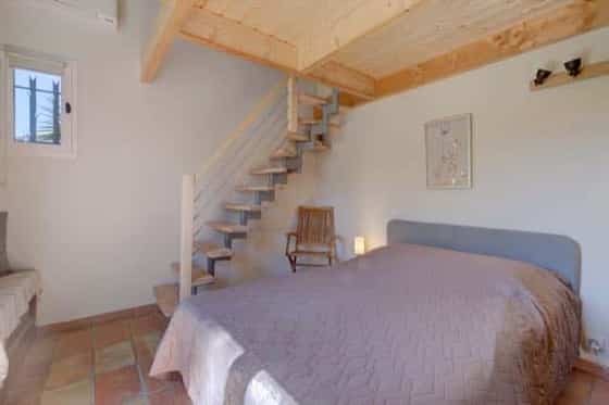 Bedroom with mezzanine stairs